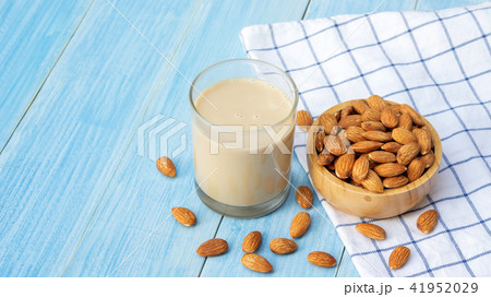 Almond milk on a blue wooden table. Almond milk on a blue wooden table. 41952029