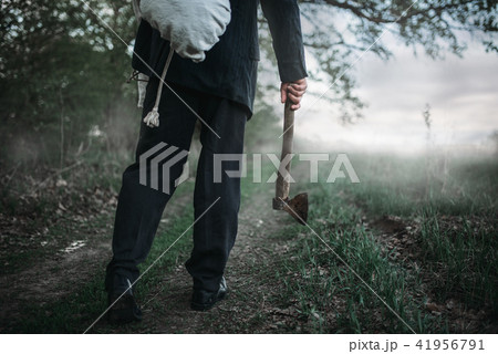 Slayer with an axe carries the victim's body 41956791