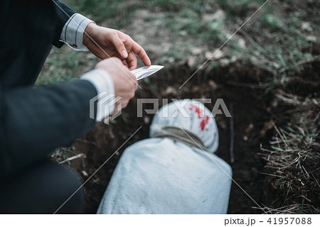 Slayer against grave, victim wrapped in a canvas Slayer against grave, victim wrapped in a canvas 41957088