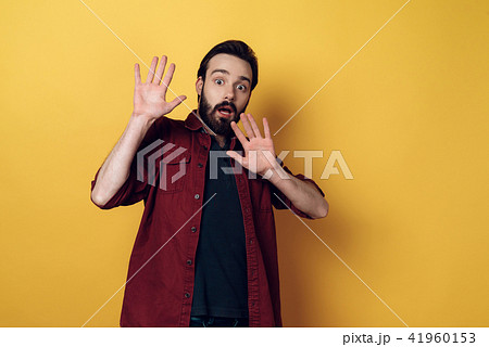 Portrait of Shocked Bearded Man keeps Hands up 41960153