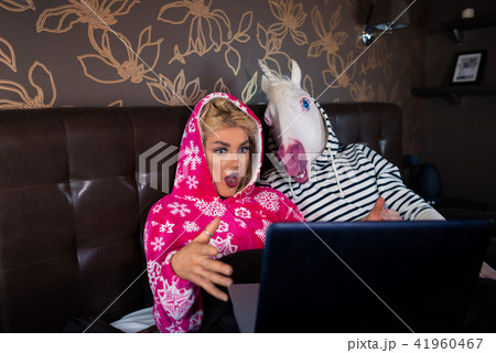 Surprised young woman is lying on the bed with funny boyfriend 41960467