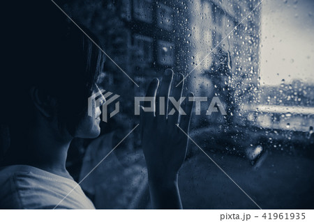 sadly woman looking out at windows raining 41961935