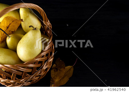 Pear basket pear orchard fresh ripe pears on dark wooden background Pear basket pear orchard fresh ripe pears on dark wooden background 41962540