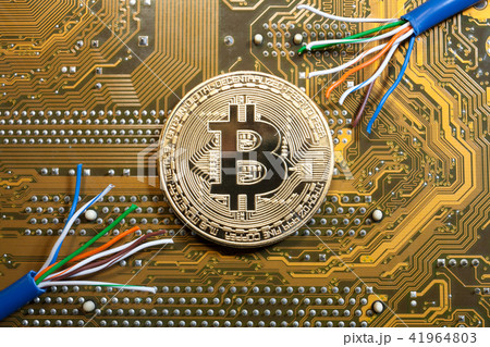 golden bitcoin coin on golden microchip close up golden bitcoin coin on golden microchip close up 41964803