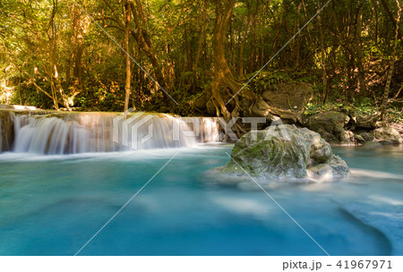 Blue stream waterfall in deep tropical forest Blue stream waterfall in deep tropical forest 41967971