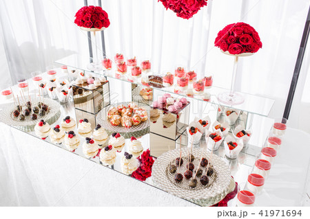 Candy bar with a lot of desserts, meringue, cupcake, fruit and sweet cakes. Sweet table for birthday Candy bar with a lot of desserts, meringue, cupcake, fruit and sweet cakes. Sweet table for birthday 41971694