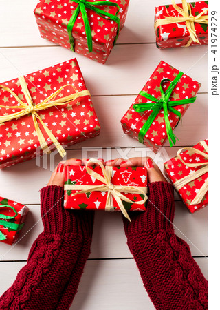 Woman holding Christmas present 41974229