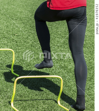 Agility drills over yellow mini hurdles no shoes 41976352
