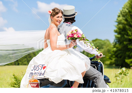 Wedding couple on motor scooter just married 41978015