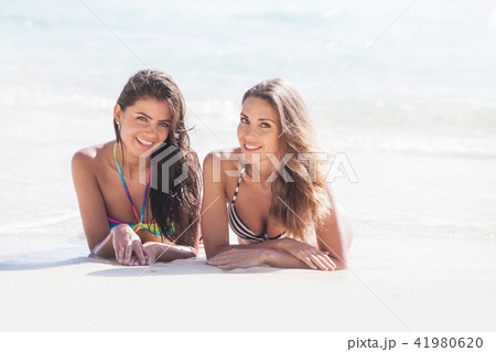 Women laying by sea Women laying by sea 41980620
