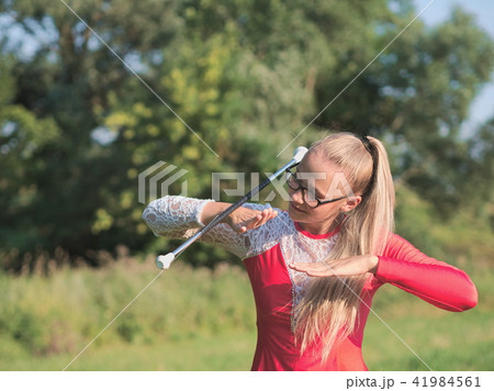 Teen Majorette Girl Twirling Baton Outdoors Teen Majorette Girl Twirling Baton Outdoors 41984561