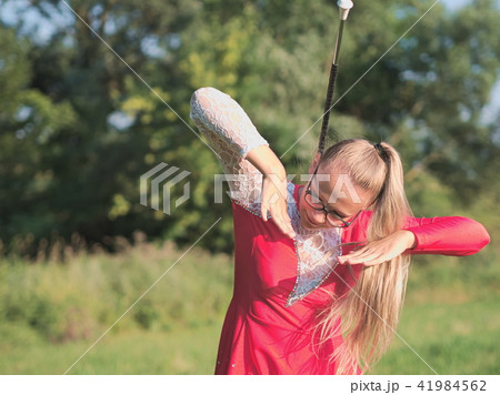 Teen Majorette Girl Twirling Baton Outdoors Teen Majorette Girl Twirling Baton Outdoors 41984562