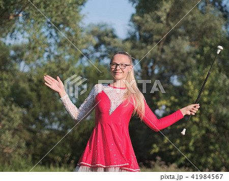 Teen Majorette Girl Twirling Baton Outdoors Teen Majorette Girl Twirling Baton Outdoors 41984567