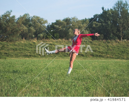 Teen Majorette Girl Twirling Baton Outdoors Teen Majorette Girl Twirling Baton Outdoors 41984571
