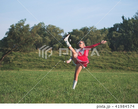 Teen Majorette Girl Twirling Baton Outdoors Teen Majorette Girl Twirling Baton Outdoors 41984574