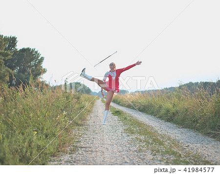 Teen Majorette Girl Twirling Baton Outdoors Teen Majorette Girl Twirling Baton Outdoors 41984577