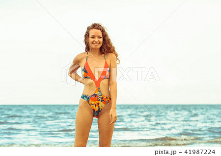 Young woman practices yoga on the beach in summer. 41987224