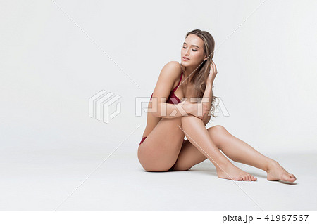 Beautiful Girl In Underwear Sitting On Floor And Meditating. Stock Photo,  Picture and Royalty Free Image. Image 95324241.