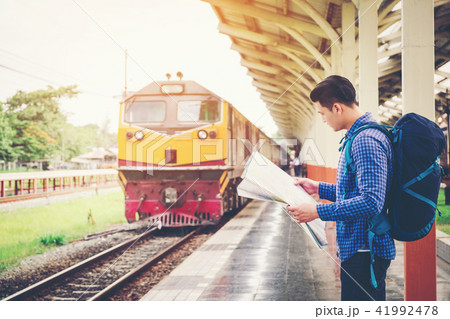 Tourist backpacker using map to travel  41992478