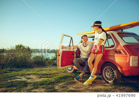 Couple resting on the beach on a summer day near river 41997690