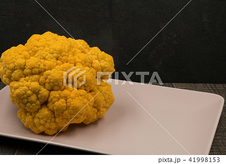 Yellow cauliflower on a pink platter Yellow cauliflower on a pink platter 41998153