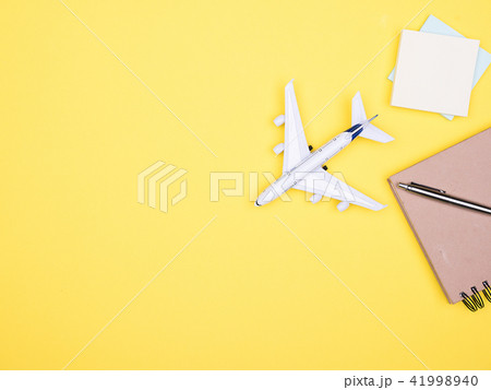 Flat lay top view of a plane on yellow backgrond Flat lay top view of a plane on yellow backgrond 41998940