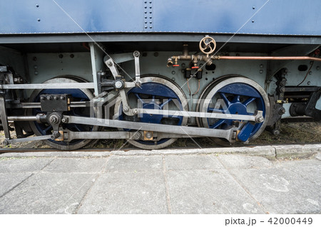 an iron wheel of a steam train an iron wheel of a steam train 42000449