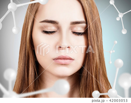 Young woman face among white molecules. 42003053