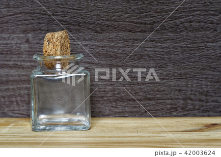 Jar with cork on wooden table, 42003624