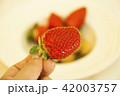Red strawberry on hand and mix fruit background 42003757