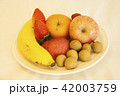mixed fresh fruits on white plate 42003759