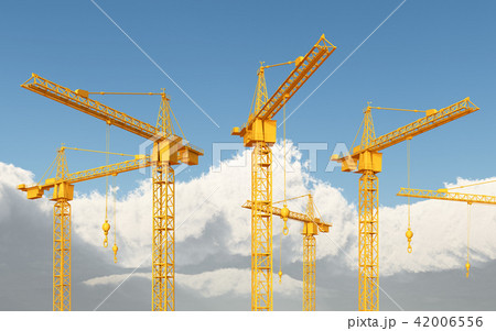 Construction cranes against a blue sky with clouds 42006556