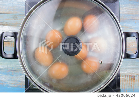 chef cooking boiled eggs in pot 42006624