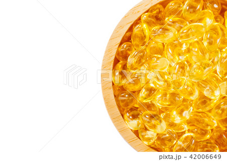 Fish oil capsule,omega,supplement in wood bowl 42006649