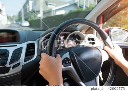 Cropped shot of hands holding wheel with driving. Cropped shot of hands holding wheel with driving. 42009773