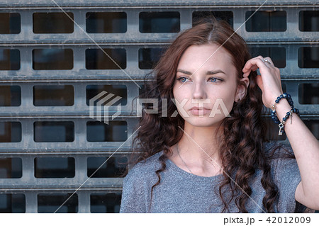Young girl in front of metal cage 42012009