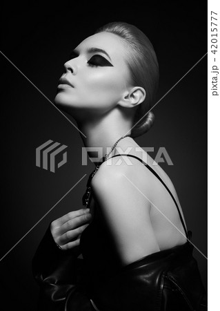 Woman with bright makeup in leather jacket 42015777