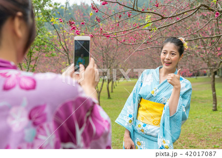 lady posing a thumb and take a picture lady posing a thumb and take a picture 42017087