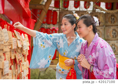 woman hanging their wishes 42017100