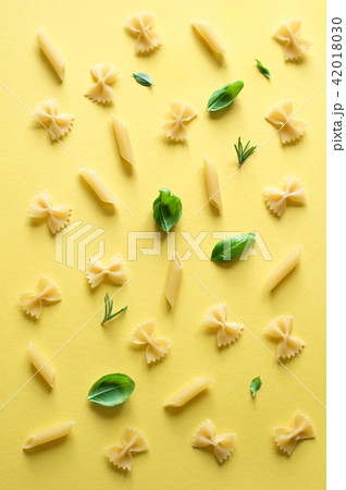 various pasta on yellow background various pasta on yellow background 42018030