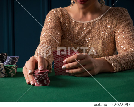 Woman playing in casino Woman playing in casino 42022998