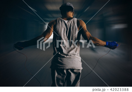 Athlete rides through a rope in the gym 42023388