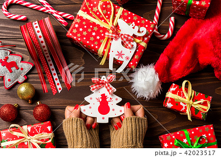 Woman holding Christmas decorations Woman holding Christmas decorations 42023517