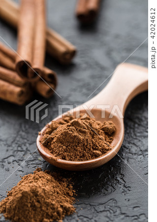 ground cinnamon spice powder in wooden spoon ground cinnamon spice powder in wooden spoon 42024612