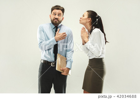 Angry boss. Man and his secretary standing at office or studio 42034688
