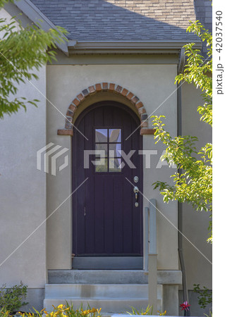 Brown front door entry with arch and stone Brown front door entry with arch and stone 42037540