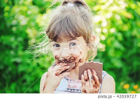 A child eats chocolate. Selective focus. 42039727