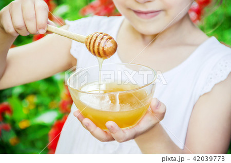 The child eats honey. Selective focus. nature. The child eats honey. Selective focus. nature. 42039773