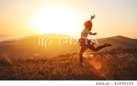 Happy woman jumping and enjoying life at sunset in mountains. Happy woman jumping and enjoying life at sunset in mountains. 42040105