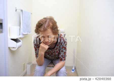 An elderly woman thinking in the toilet - Stock Photo [42040360] - PIXTA